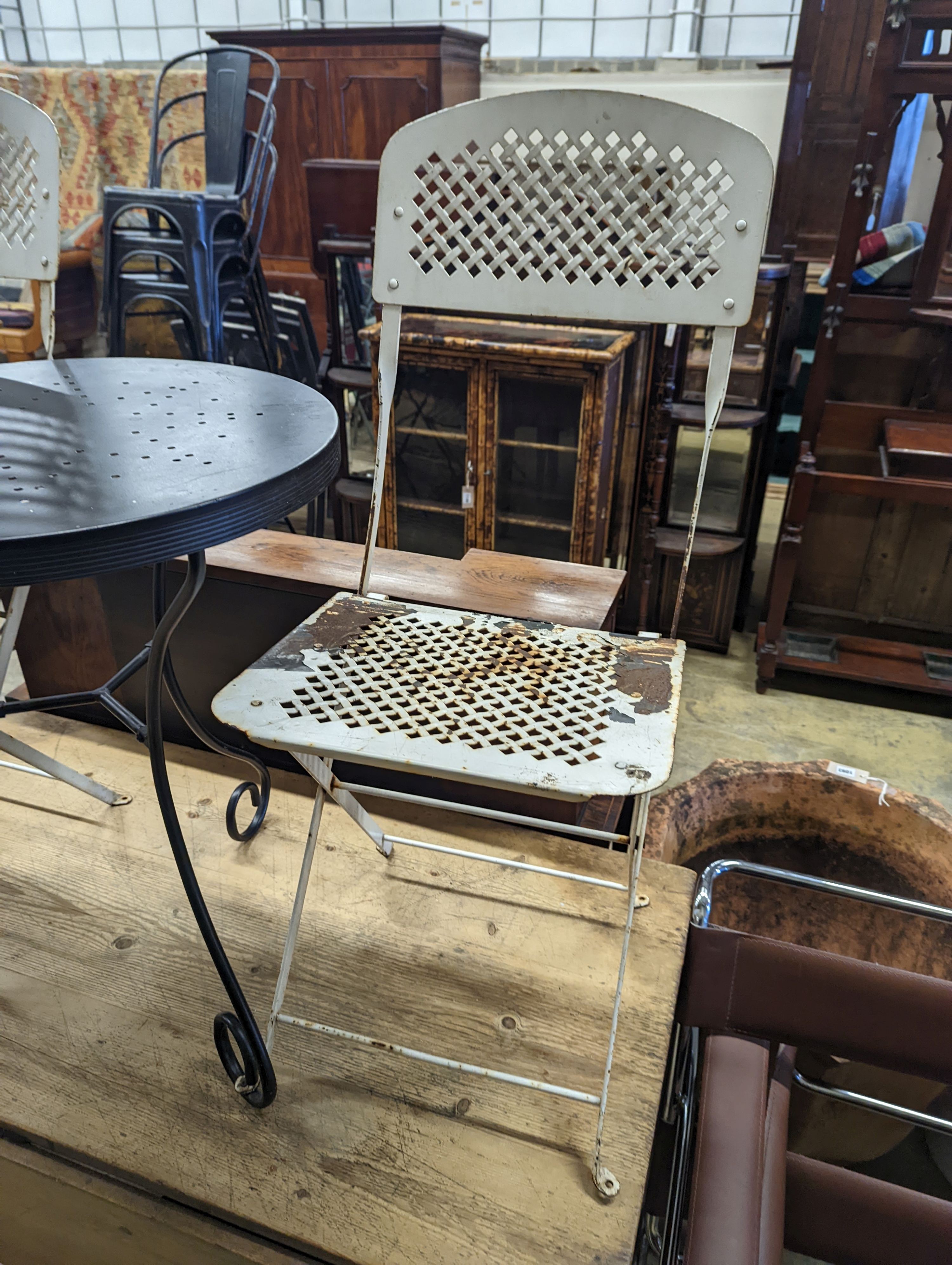 A circular metal bistro table, diameter 49cm, height 65cm and two chairs